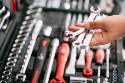 Chooses wrench tools (screwdriver) in store (shop)